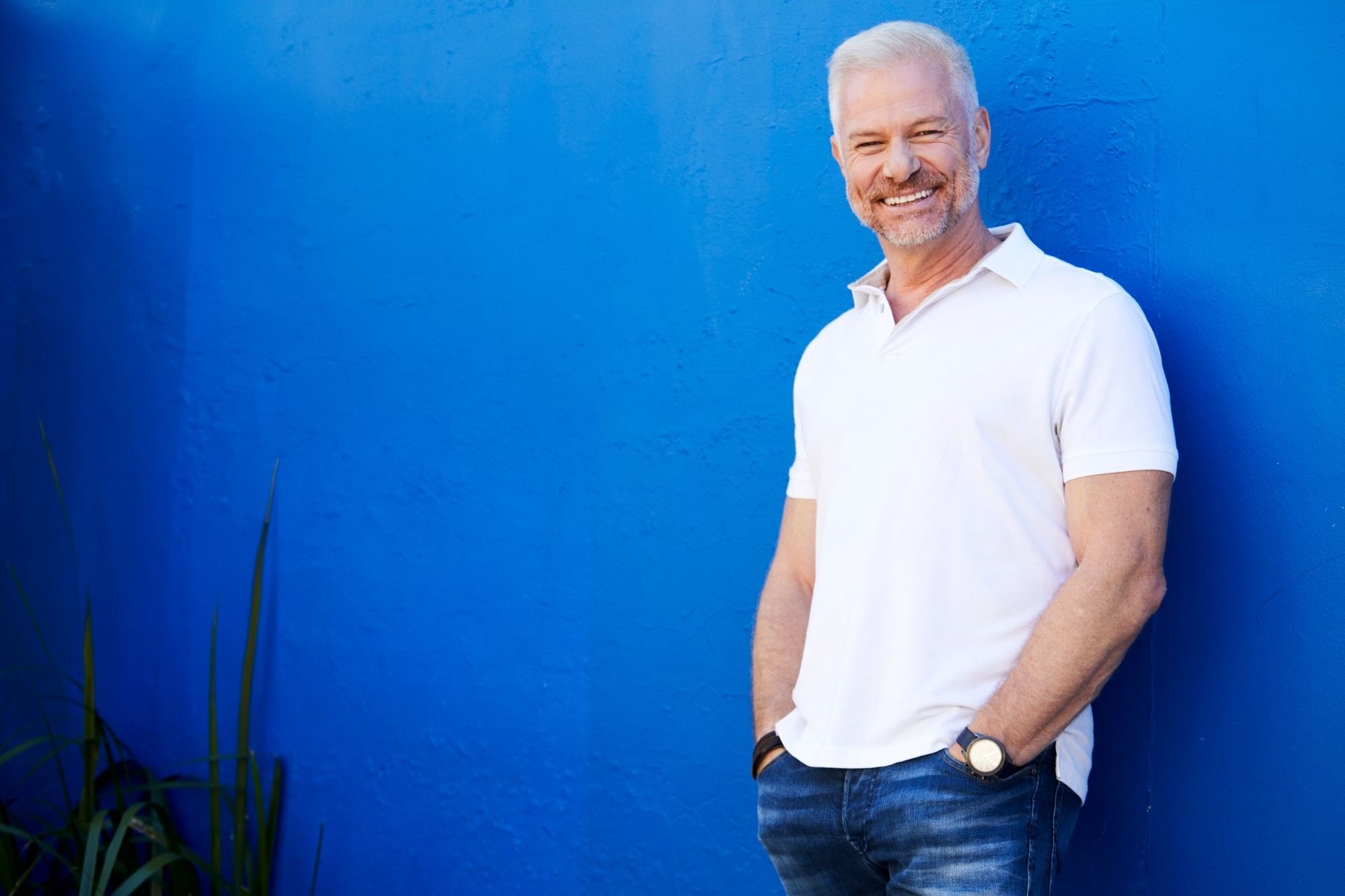 David Francis, founder of Business Point, standing against a cobalt blue wall
